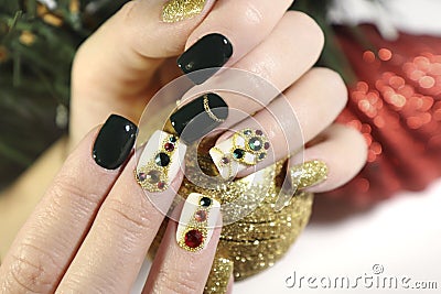 New year`s fashionable beautiful festive manicure on short square nails with green lacquer color. Stock Photo