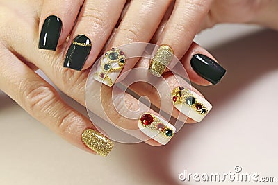 New year`s fashionable beautiful festive manicure on short square nails with green lacquer color. Stock Photo