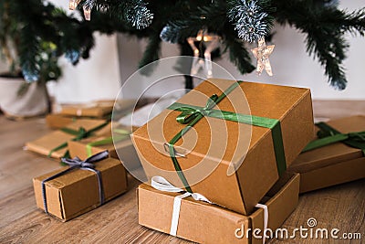 New Year`s gifts under the tree. festive craft boxes under the spruce. surprise and joy for children Stock Photo