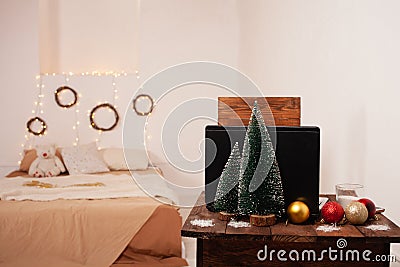 New Year`s interior, decoration of the desktop and bedroom for Christmas. Boke, lights, Christmas trees, balloons, a table with a Stock Photo