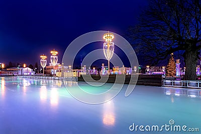 New Year s night skating rink, Moscow, Russia. Christmas illumination and lights reflected on ice Editorial Stock Photo
