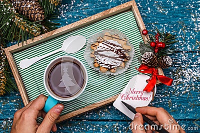 New Year`s photo of tea with the image of Christmas tree, cake Stock Photo