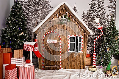 New Year`s photo zone with snow near a wooden toy house Stock Photo