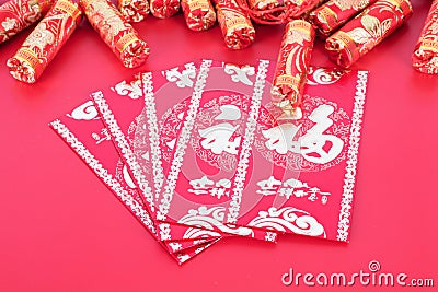 New Year`s red envelopes and firecracker decorations.The Chinese characters in the picture mean `happiness` Stock Photo