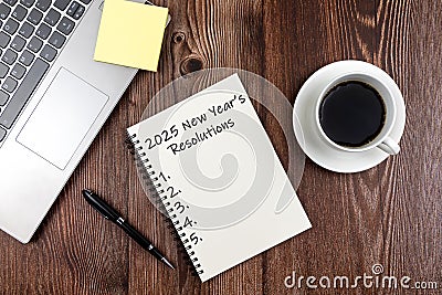 New Year's Resolutions 2025 text on note pad stock photo on wood desk Stock Photo