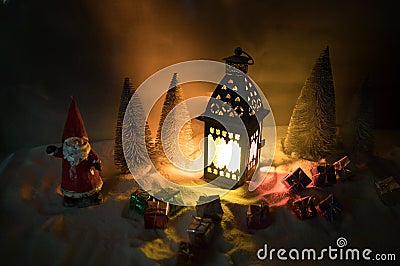 New Year\'s still-life postcard lamp covered in snow with glowing candle at night Stock Photo