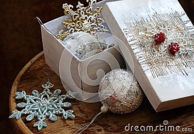 New Year's toys in a white box on a wooden table Stock Photo