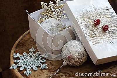 New Year's toys in a white box on a wooden table Stock Photo