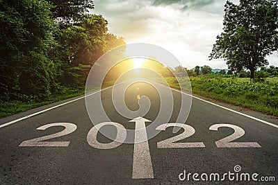 New year 2022 or straightforward concept. Text 2022 written on the road in the middle of asphalt road at sunset.Concept of plannin Stock Photo