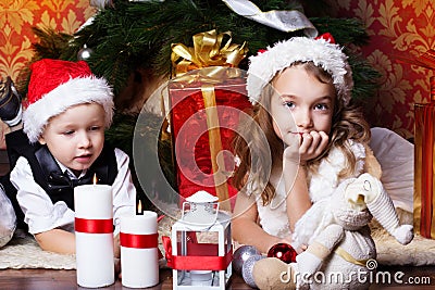 New year time. Happy childrens with cristmas presents near the fur-tree Stock Photo