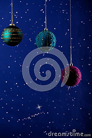 A New year's card. Beautiful cristmas decorations colored balls on a blue background with stars Stock Photo