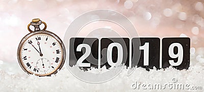 2019 New Years eve celebration. Minutes to midnight on an old watch, bokeh festive background Stock Photo