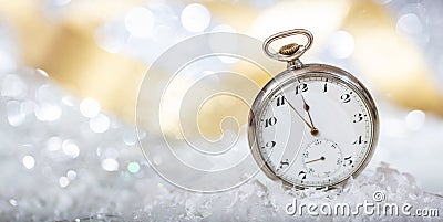 New Years eve countdown. Minutes to midnight on an old pocket watch, bokeh background Stock Photo