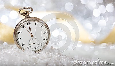 New Years eve countdown. Minutes to midnight on an old watch, bokeh festive Stock Photo