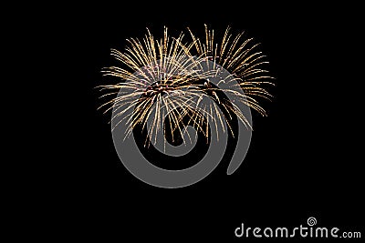 New Years Eve fireworks, two tacets exploding like two wonderful bouquets of flowers in yellow orange red light in front of a Stock Photo