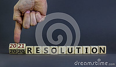 2021 new years resolution. Male hand flips wooden cubes and changes words `2020 resolution` to `2021 resolution`. Beautiful gr Stock Photo