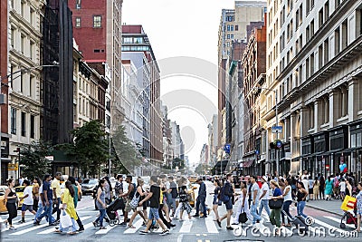 NEW YORK CITY - CIRCA 2017: Crowds of busy people walk across th Editorial Stock Photo