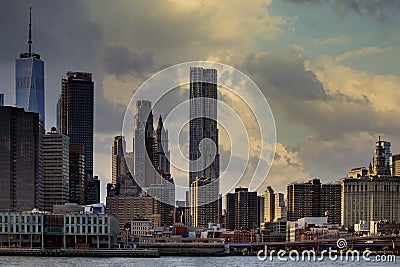 New York City Harbor on a barge sails up the east river against the lower Manhattan skyline standing tall Stock Photo