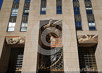 Wisdom, an art deco frieze by Lee Lawrie over the entrance of GE Building at Rockefeller Plaza in New York Editorial Stock Photo