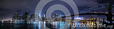 New York City, NY/USA - circa July 2015: Panorama of Brooklyn Bridge and Lower Manhattan by night Editorial Stock Photo