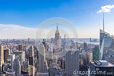 New York City Skyline in Manhattan downtown with Empire State Building and skyscrapers on sunny day with clear blue sky USA Stock Photo