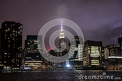 The New York City Skyline at night from the East River looking at Manhattan Stock Photo