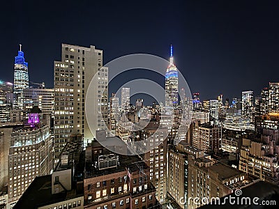 New York city skyscrapers at night with empire state view building seen from a rooftop bar Editorial Stock Photo