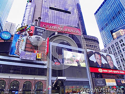 New York City Times Square on a sunny winter day, the Crowne Plazza Hotel and Hersheys store. Editorial Stock Photo