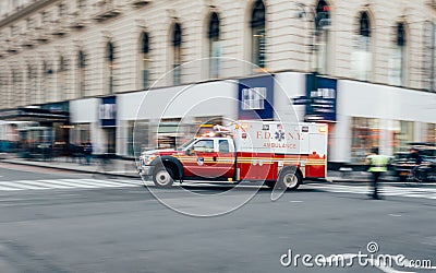 New York City, USA - March 18, 2017: FDNY Ambulance flashing lights siren blasting speed through midtown rush hour traffic in Editorial Stock Photo