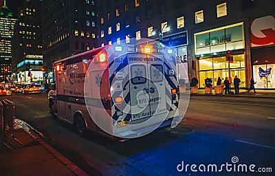 New York City, USA - March 18, 2017: FDNY Ambulance flashing lights siren blasting speed through midtown rush hour traffic in Editorial Stock Photo