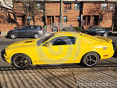 New York City, USA - March 18, 2024: Ford Mustang GT coupe yellow sportscar outdoor, side view Editorial Stock Photo