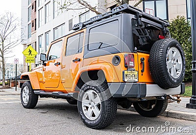New York City, USA - March 31, 2024: 2012 Jeep Wrangler Unlimited Sahara yellow car parked outdoor, rare view Editorial Stock Photo