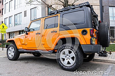 New York City, USA - March 31, 2024: 2012 Jeep Wrangler Unlimited Sahara yellow car parked outdoor, side corner view Editorial Stock Photo
