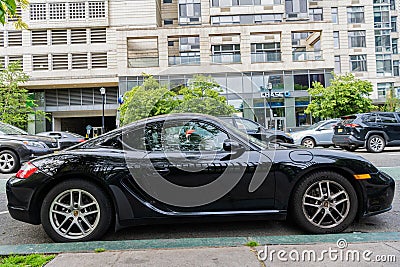 New York City, USA - May 11, 2024: 2011 Porsche Cayman. Black Porsche Cayman parked outdoor. Luxury Porsche Cayman, side Editorial Stock Photo