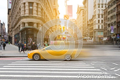 New York City yellow taxi cab in motion across broadway Stock Photo