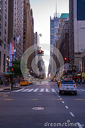 New York crowds and traffic at night. Empty road goes through Manhattan island near Time Square Editorial Stock Photo