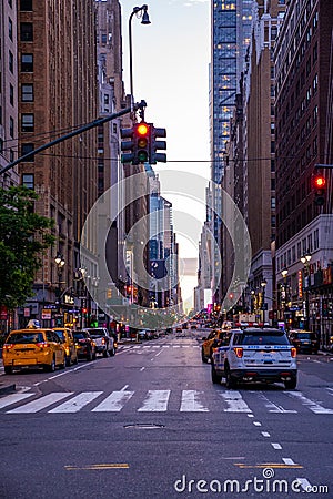 New York crowds and traffic at night. Empty road goes through Manhattan island near Time Square Editorial Stock Photo