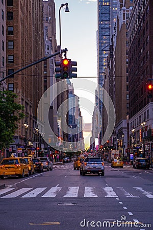 New York crowds and traffic at night. Empty road goes through Manhattan island near Time Square Editorial Stock Photo