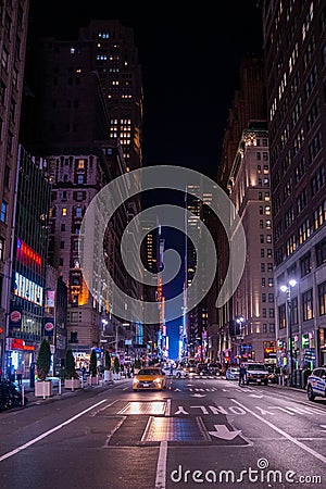 New York crowds and traffic at night. Empty road goes through Manhattan island near Time Square Editorial Stock Photo