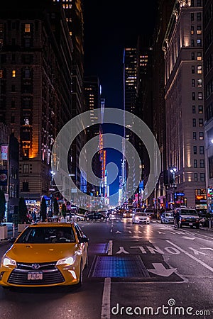 New York crowds and traffic at night. Empty road goes through Manhattan island near Time Square Editorial Stock Photo