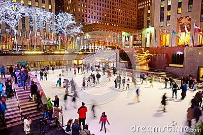 NEW YORK - MARCH 18, 2015: Tourists and newyorkers skate in the famous Rockefeller Center skatink rink, New York City. Editorial Stock Photo