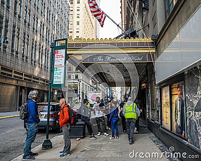 Unidentified migrants in front of New York City's new migrant welcome center at the former four-star Roosevelt Hotel Editorial Stock Photo