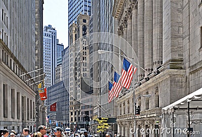 New York, Wall Street stock exchange with classic columns and old architecture and colorful flags of united states of Editorial Stock Photo