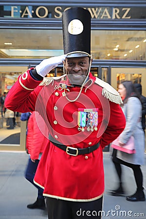 A doorman dressed as a toy soldier stands outside newly reopened the FAO Schwarz flagship store at Rockefeller Plaza Editorial Stock Photo