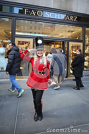 A doorman dressed as a toy soldier stands outside newly reopened the FAO Schwarz flagship store at Rockefeller Plaza Editorial Stock Photo