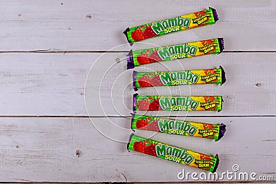 Mamba chewy candy individually wrapped made by August Storck KG on old wooden background Editorial Stock Photo