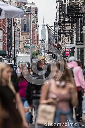 New York, NY, USA - May 17, 2018: Crowds of people walking sidewalk of Broadway avenue in Soho of Midtown Manhattan on Editorial Stock Photo
