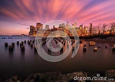 New york skyline seen from the bay with moon and sticks on the water and skyscrapers on the background Stock Photo