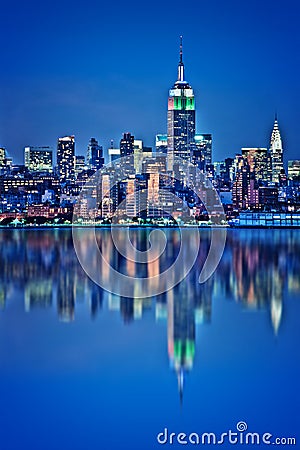 New York skyline with water reflections at night Stock Photo