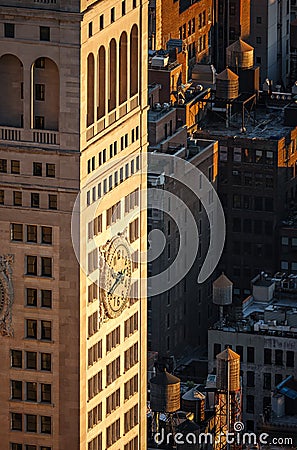 New York skyscraper at sunset with rooftop wooden water tanks Stock Photo